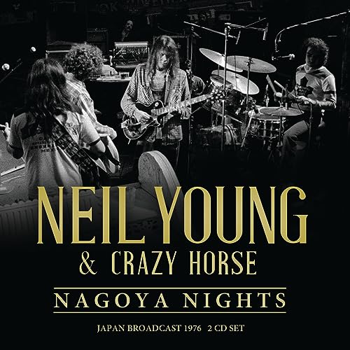 Black and white photo of Neil Young and Crazy Horse performing on stage.