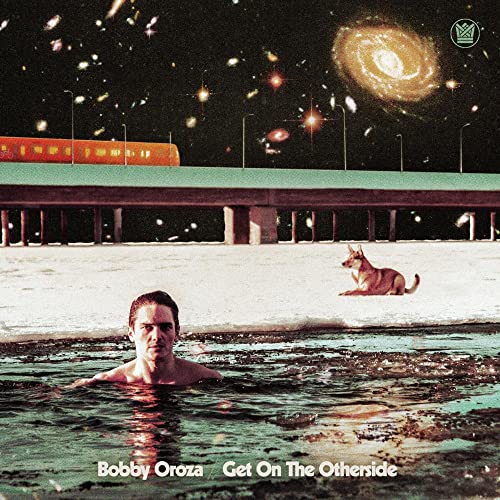 A man in dark water with a dog on a snowy bank under a galaxy.