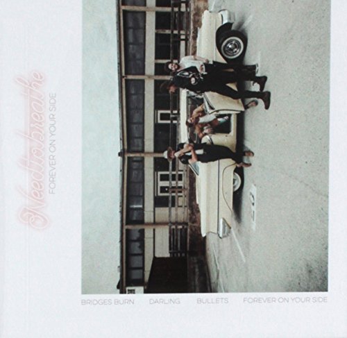 Needtobreathe band posing with a vintage car in front of a building.
