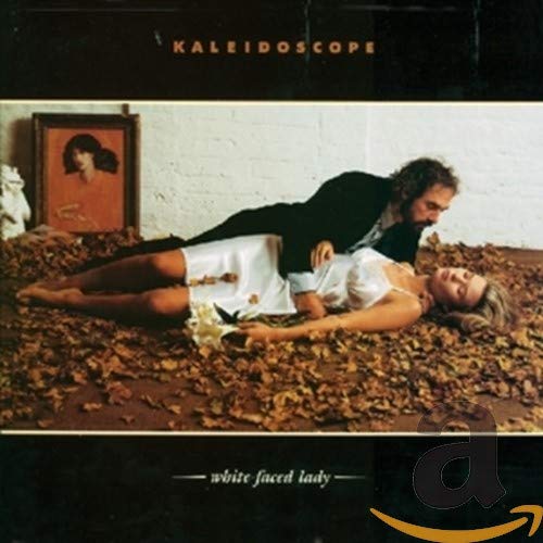Album cover: couple embracing amongst autumn leaves, portrait in background.