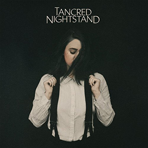 Album cover: woman with dark hair, wearing white shirt and suspenders.
