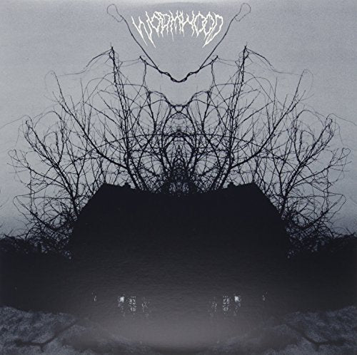 Dark album cover with bare trees and a shadowy house, "Wormwood" text.