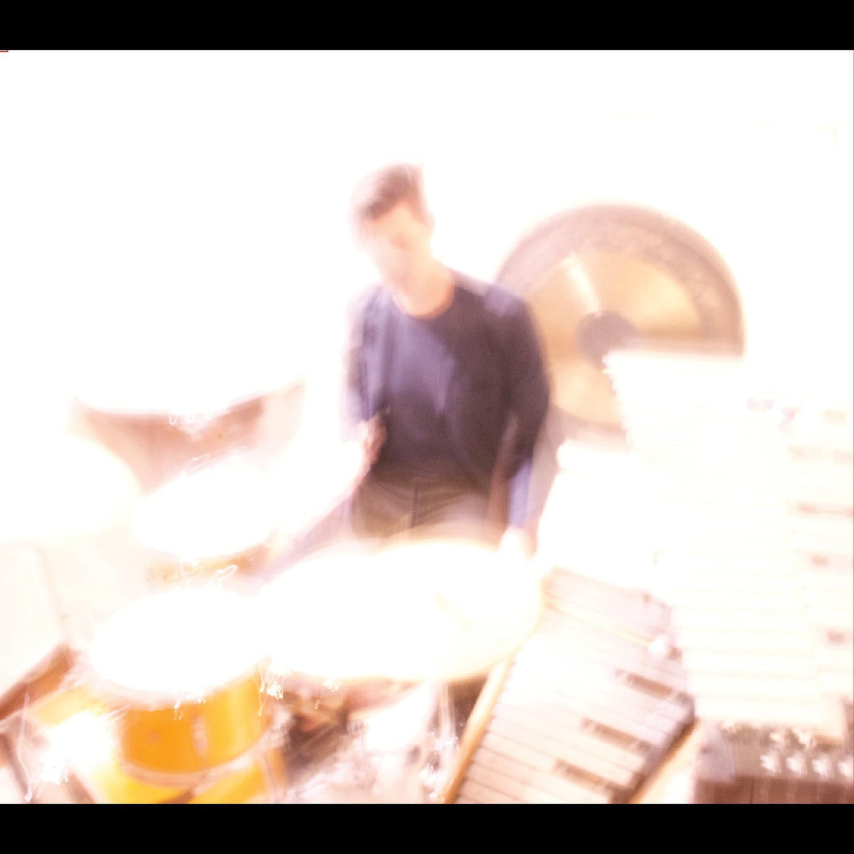 Blurred image of a person playing drums, CD titled "The Self.