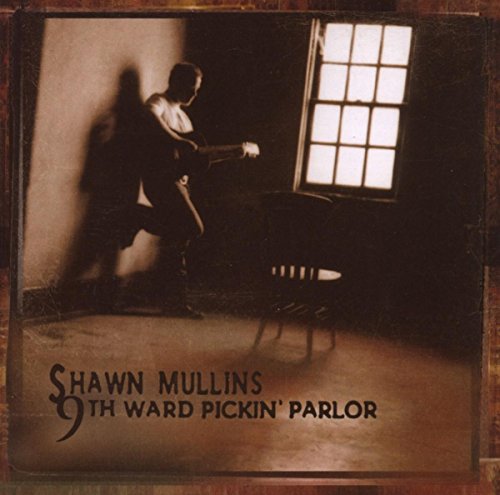 Shadowy figure with guitar near a window, album cover for Shawn Mullins.