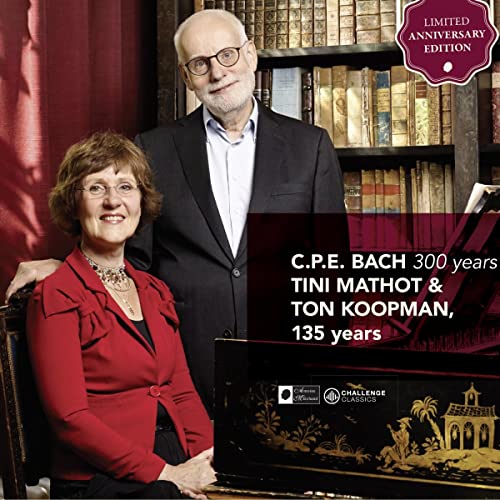 Two musicians, Tini Mathot and Ton Koopman, with a piano and books.