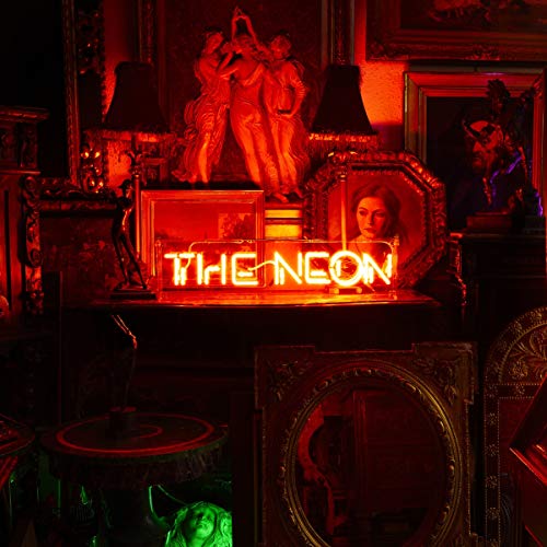 Red-lit room with a glowing "THE NEON" sign and ornate frames.