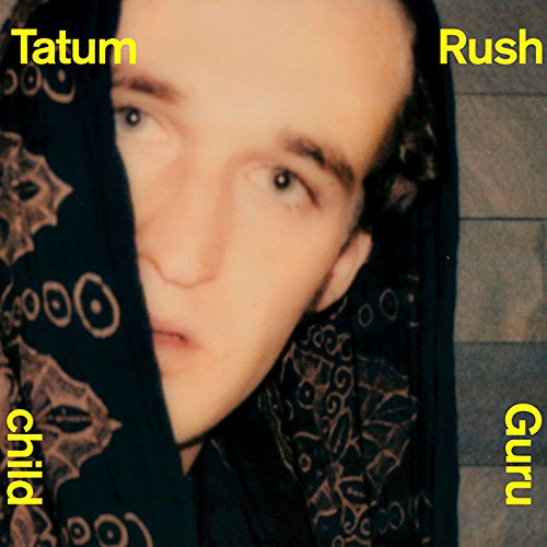 Close-up portrait of a young person with a patterned scarf, album cover.