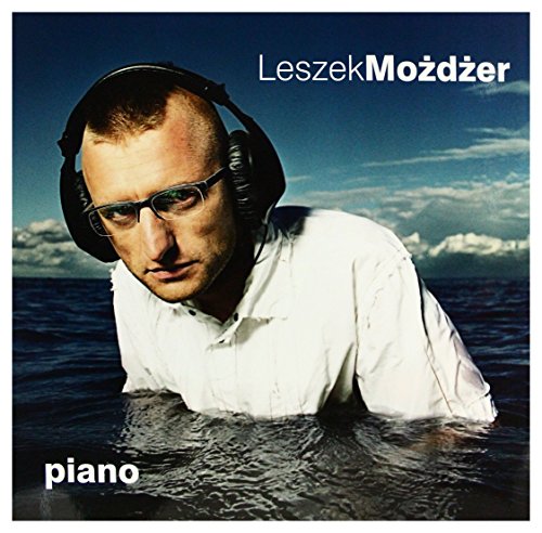 Leszek Możdżer album cover: man with headphones submerged in water.