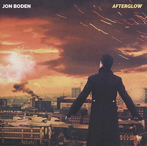 Album cover: man in coat views fireworks over a city skyline.