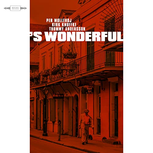 CD cover: red street scene with a man walking in New Orleans.