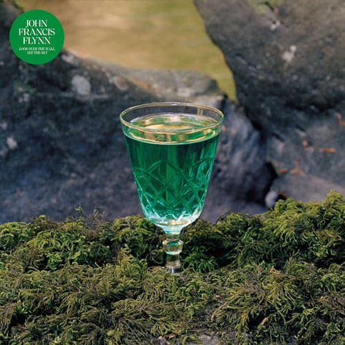 Album cover: green glass with liquid, moss, and rocky background.