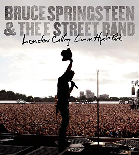 Bruce Springsteen on stage, silhouetted against a large concert crowd.