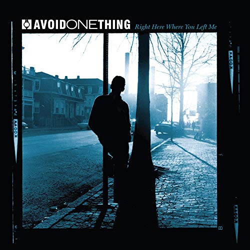 CD cover: silhouetted figure stands on a city street in blue tones.