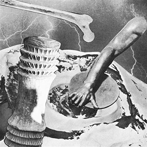 Black and white album cover with surreal imagery of bones and a tower.