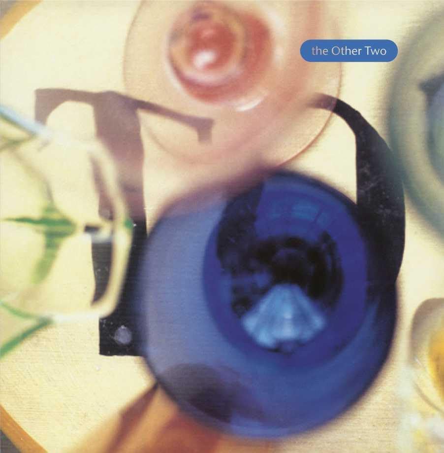 Close-up of a blue eye with a snail shell, album cover art.