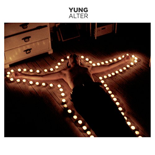 Album cover for Yung’s “Alter” featuring a dimly lit room with candles.
