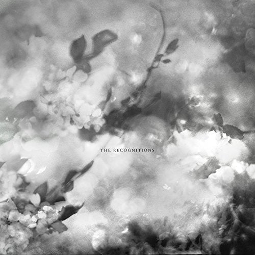 Black and white album cover with blurred floral imagery and text.