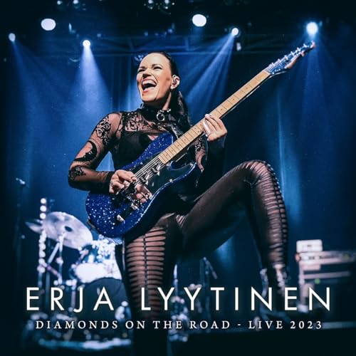 Erja Lyytinen playing a blue electric guitar on stage, live 2023.