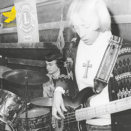 Black and white photo of two musicians with a drum kit and bass guitar.
