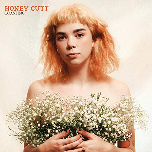 Woman with orange hair holding white flowers, album cover.