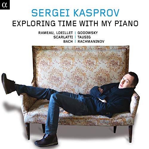 CD cover: pianist lounging on a floral patterned antique sofa.