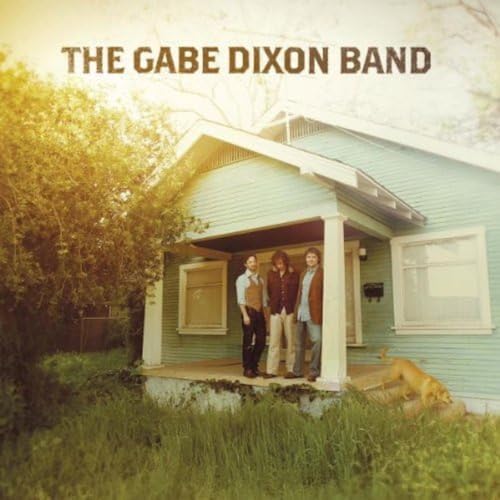 CD cover: three people stand in front of a light blue house.