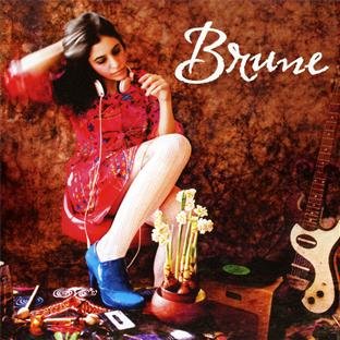 Woman with headphones, flowers, guitar, and record player on a textured background.