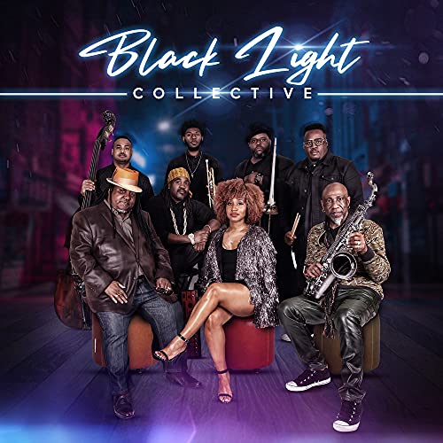 Black Light Collective, a group of eight musicians, posing for a portrait.