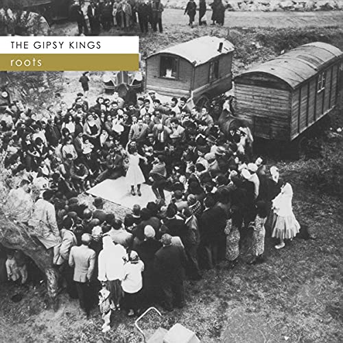 Black and white photo of a large crowd gathered around dancers and wagons.
