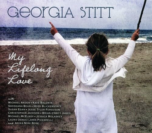 CD cover: woman with arms raised on a beach, ocean background.