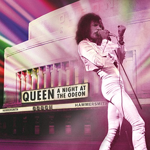 Freddie Mercury singing into a microphone on stage at Hammersmith Odeon.