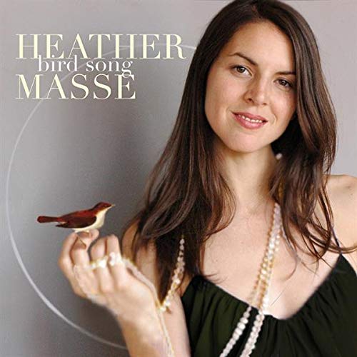 Heather Masse holds a small bird on her finger on the Bird Song album cover.
