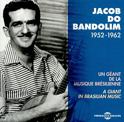 Black and white photo of Jacob do Bandolim holding a mandolin on blue background.