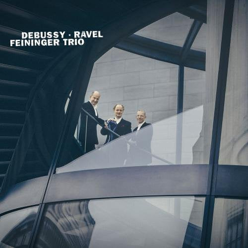 CD cover featuring three formally dressed musicians framed by modern architecture.