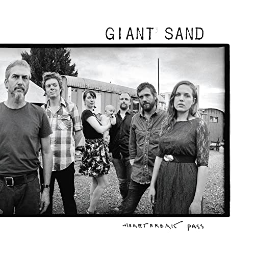 Black and white album cover featuring a group portrait and band name.