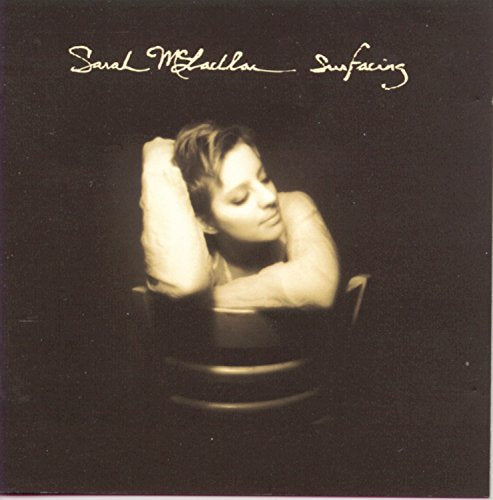 Sarah McLachlan's "Surfacing" CD cover: woman resting arms on chair.