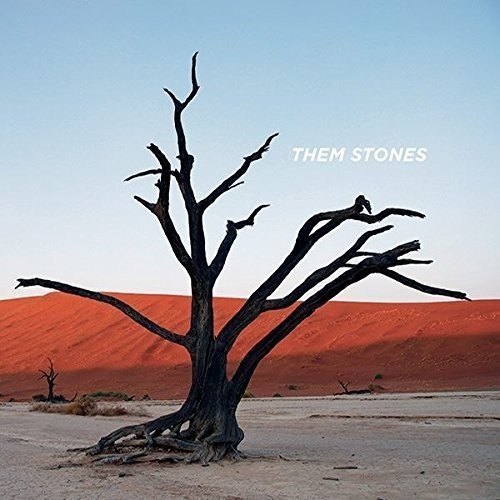 CD cover: stark, bare tree against orange sand dunes, text “THEM STONES”.