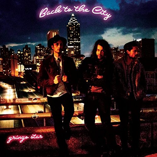 Album cover: three men in front of a city skyline at night.