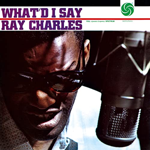 Ray Charles portrait singing into a microphone, album cover.