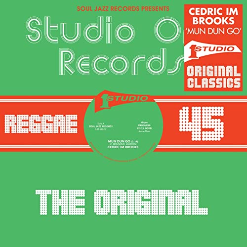 Vinyl record label for Cedric Im Brooks’ “Mun Dun Go” with red text.