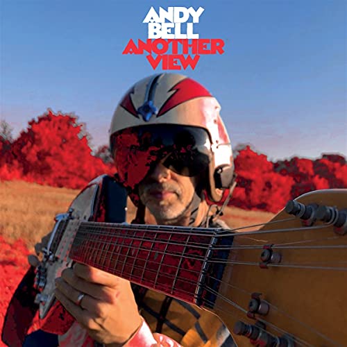 Andy Bell album cover: man in helmet playing guitar, red trees.