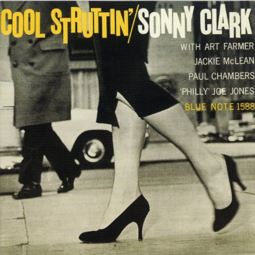 Album cover showing a woman's legs in high heels walking past a man.