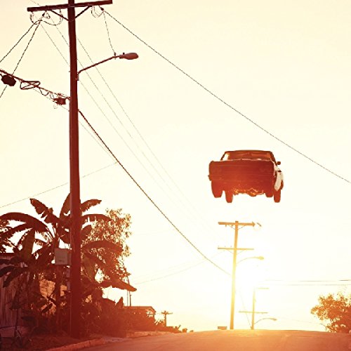 Vinyl album cover: car seemingly floating in a sunset sky.