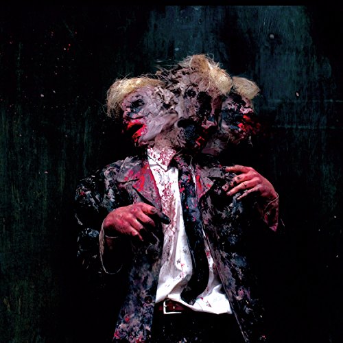 Distorted, multi-faced portrait of a person in a suit, splattered with red.