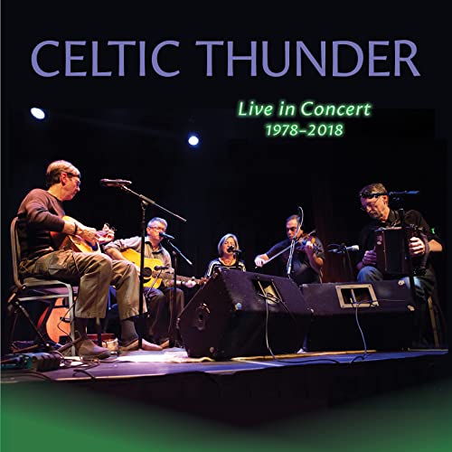 Celtic Thunder band performing live on stage with instruments.