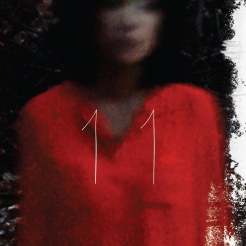 Red album cover with the number 11 and obscured face.