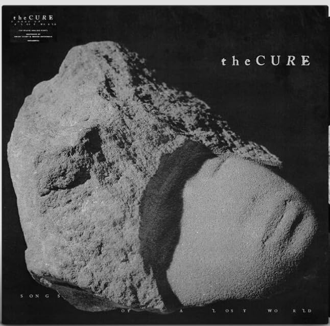 The Cure “Songs Of A Lost World” vinyl record cover, rocky texture.