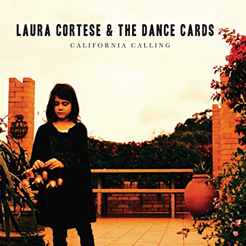 CD cover: woman in black dress stands in a garden.