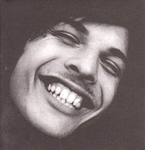 Black and white portrait of a smiling man, album cover art.