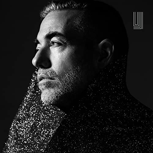 Black and white portrait of a man with dissolving, sparkling texture.